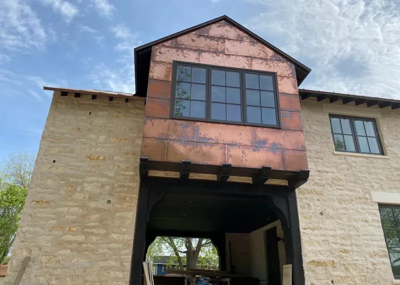 Copper metal panel facade on a stone building for Roof Repair in North Ogden